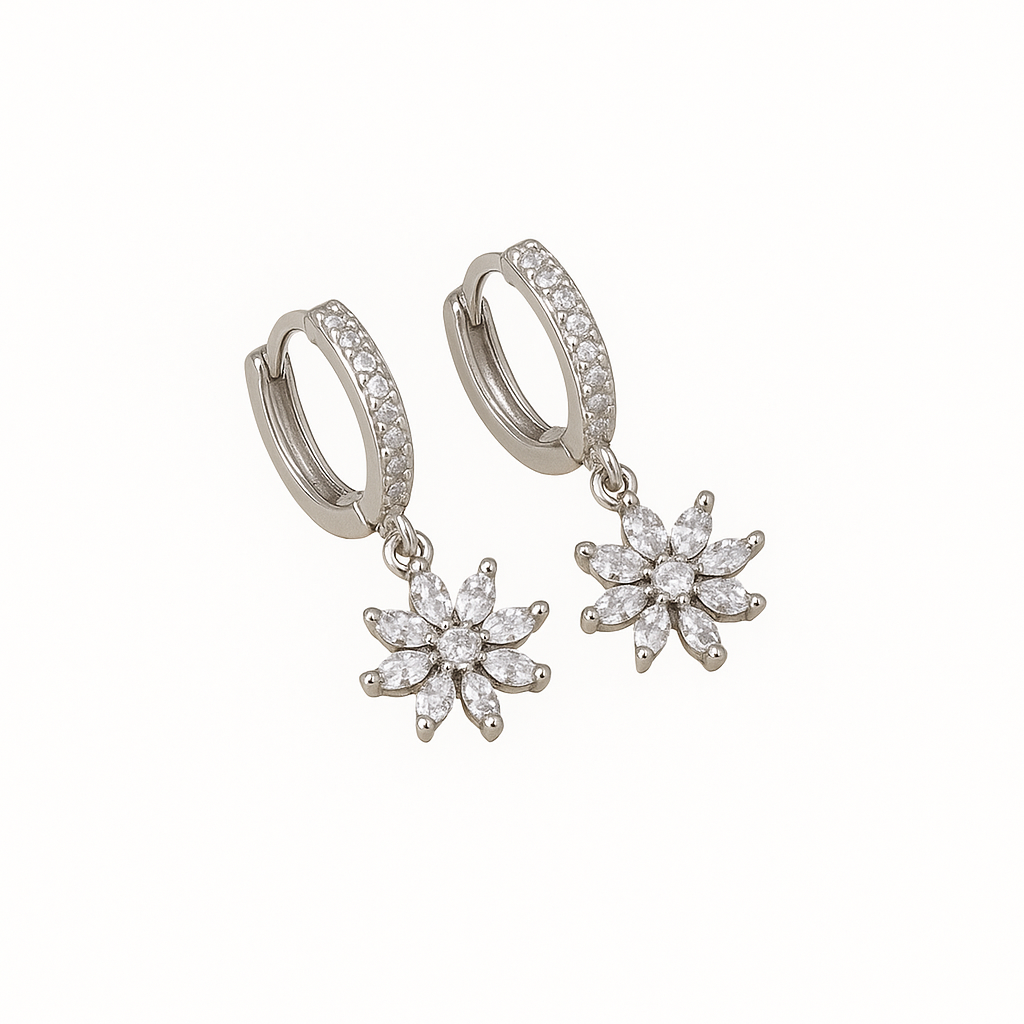 Silver huggie earrings with delicate flower detailing. Lightweight, feminine and perfect for adding a soft, everyday statement.