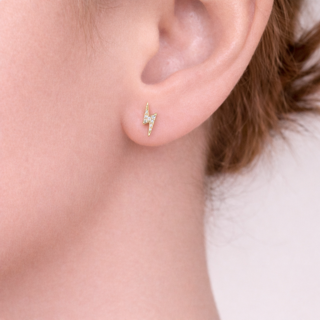 Gold lightning bolt stud earrings me the label