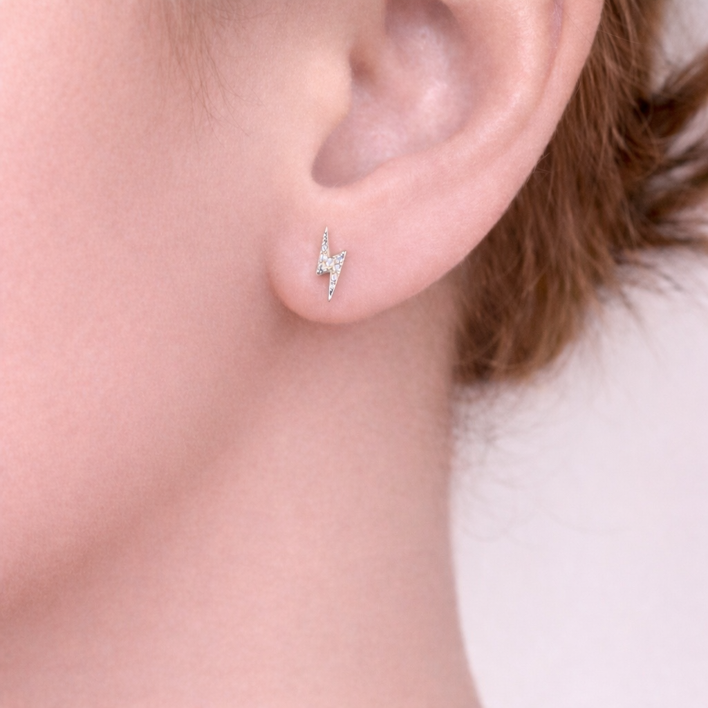 Silver lightning bolt stud earrings me the label